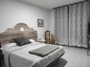 Ένα ή περισσότερα κρεβάτια σε δωμάτιο στο TANISHOSTALRESTAURANTE