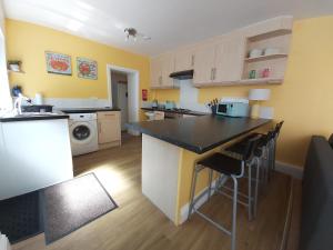 a kitchen with a large island in a room at Beautiful Two Bedroom ground floor apartment in Swansea