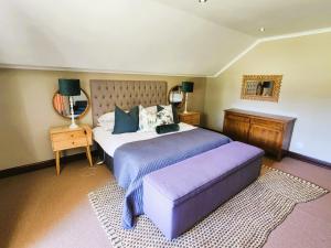 a bedroom with a large bed and a mirror at Main Home 4 Rawdons Estate in Nottingham Road