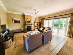 a living room with two couches and a fireplace at Main Home 4 Rawdons Estate in Nottingham Road