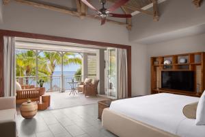 a bedroom with a bed and a view of the ocean at JW Marriott Mauritius Resort in Le Morne