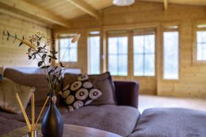 a living room with a couch and a table at Cabin in the countryside in Sible Hedingham