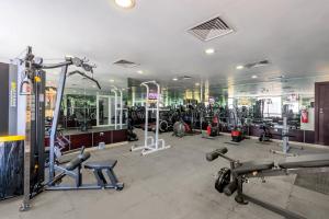 a gym with a lot of treadmills and machines at Plaza Inn Doha in Doha