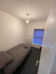 a bedroom with a bed and a window at Neat Retreat-Cilfynyd-Pontypridd in Pontypridd