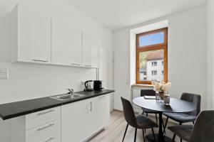 a kitchen and dining room with a table and a window at FarawayHomes Studio Sankt Michael #5 in Liesingthal +11 photos