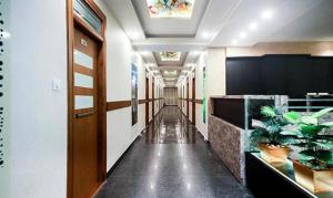 a hallway of a office with plants in it at FabHotel Prime Suloka Towers in Kushālnagar