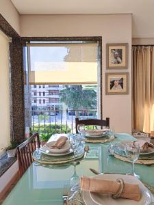 a table with plates and glasses on it with a window at Casa Ponte Pedrinha in Tarouca