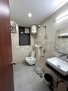 a bathroom with a toilet and a sink at Aura Luxury Studio Near Golf Course Road, Sector 57, Gurgaon in Gurgaon
