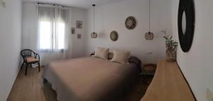 A bed or beds in a room at Hostal Sa Malica