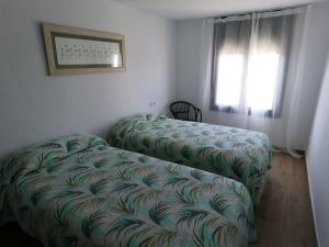 A bed or beds in a room at Hostal Sa Malica