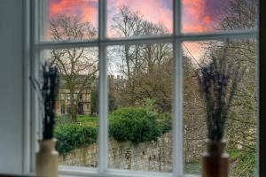 a window with a view of a city seen through it at Apartment 8 - Bootham House in York