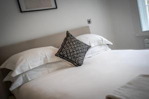 a white bed with two pillows on top of it at Apartment 8 - Bootham House in York