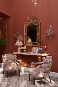 a room with a mirror and a table and chairs at Château de Théoule Hôtel & Spa in Théoule-sur-Mer +99 photos
