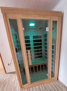 a large glass cabinet in a room at Sunflower House with SPA and Sauna in Vitanje