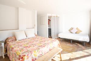 A bed or beds in a room at Hostal Sa Malica