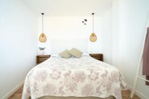 A bed or beds in a room at Hostal Sa Malica