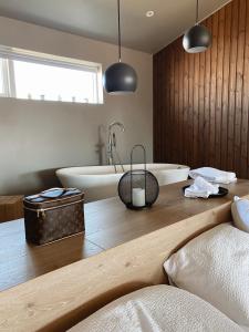 a bathroom with a bath tub and a sink at Stracta Hotel in Hella