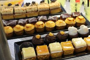 a display of different types of cakes and pastries at Tacande Portals in Portals Nous