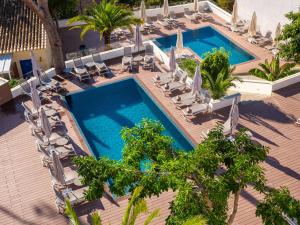 an overhead view of a swimming pool with chairs and trees at Tacande Portals in Portals Nous