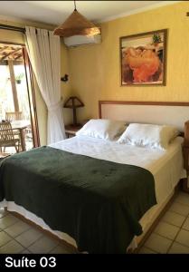 a bedroom with a large bed in a room at Casa Santa Felicidade - Gravatá in Gravatá