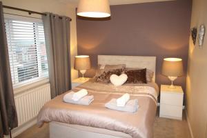 a bedroom with a bed with two towels on it at 3 Bed House - Sleeps 6 - Fully Refurbished in Ryton
