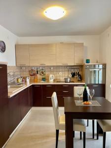 a kitchen with a table and chairs and a dining room at Family House with pool & sea view in Bijela