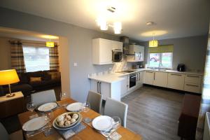 a kitchen and living room with a dining table and a kitchen and a dining room at 3 Bed House - Sleeps 6 - Fully Refurbished in Ryton