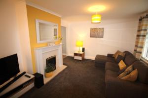 a living room with a couch and a fireplace at 3 Bed House - Sleeps 6 - Fully Refurbished in Ryton