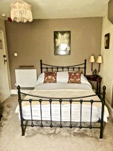 a bedroom with a large bed with pillows on it at Mulberry House in Llandudno