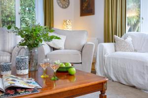 a living room with a coffee table with glasses of wine at Toller House in Exmouth