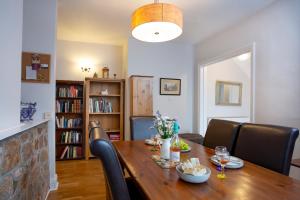 a dining room with a wooden table and chairs at Toller House in Exmouth