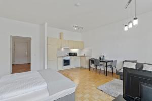 a bedroom with a bed and a kitchen with a table at StayEasy Apartments Krieglach W1 