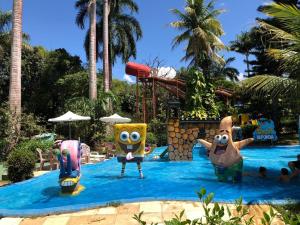 a group of inflatable characters in a water park at Ytacaranha Hotel de Serra in Meruoca +1 photo