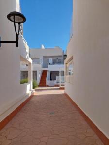 a walkway between two white buildings with a street at HACIENDA DEL MARQUES III To Chill in Cuevas del Almanzora