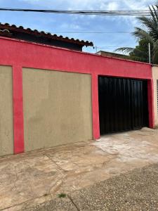 un bâtiment rouge avec deux portes de garage dans l'établissement Cozy, à Palmas