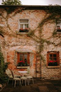 a table and chairs outside of a brick building at BioRezydencja in Świeradów-Zdrój