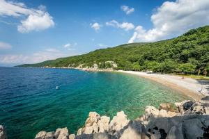 a view of a beach with rocks in the water at Apartment Beach Stara Porozina in Porozina
