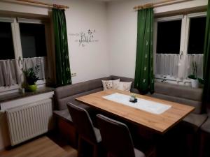 a dining room with a table and a couch at Appartement Kieler in Haus im Ennstal +23 photos