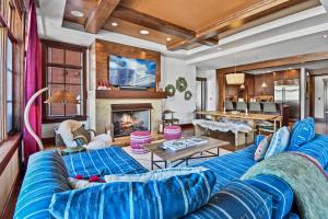 a living room with a blue couch and a fireplace at Flagstaff #203 in Park City