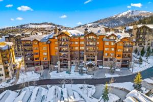 an apartment complex in the winter with snow on the ground at Flagstaff #203 in Park City