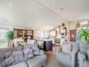 a living room with two couches and a kitchen at Sea View Lodge in Horden