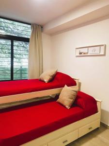 1 dormitorio con 2 camas y ventana en Allende Suite Departamentos en Villa Allende