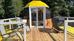 a yurt with a grill on a wooden deck at Sam’Relax Plus in Tracadie