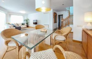 a living room with a glass table and chairs at Cozy Apartment In Castell De La Plana With Wifi in Castellón de la Plana