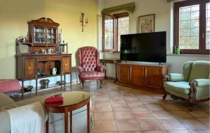 a living room with a flat screen tv and chairs at Cozy Home In Pescara With Wifi in Pescara