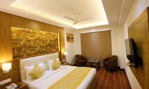a hotel room with a bed and a flat screen tv at FabHotel Prime Star 17 in New Delhi