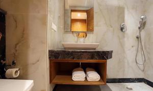a bathroom with a sink and a counter with towels at FabHotel Prime Star 17 in New Delhi