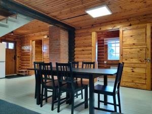 a dining room with a black table and chairs at Tapa Cottage next to disc golf. in Tapa