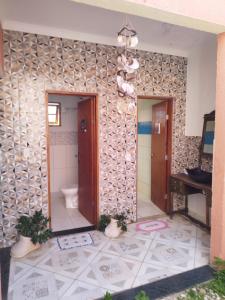 a bathroom with a toilet in a room at Sítio refúgio do lago in Piracicaba