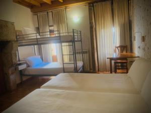 Postel nebo postele na pokoji v ubytování Hostal As Margaritas